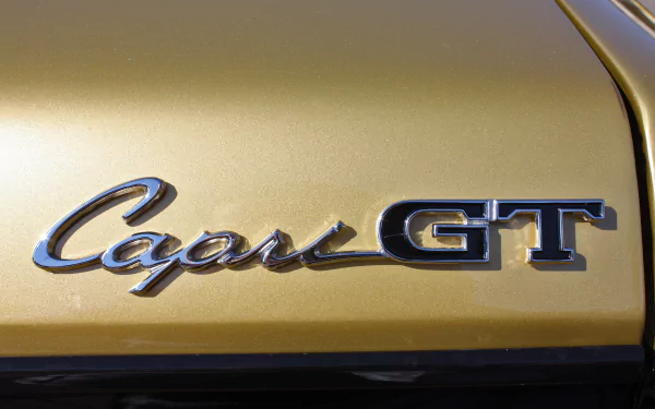 Close-up of the Mercury Capri GT emblem on a gold vehicle, presented as a 4K Ultra HD desktop wallpaper and background.