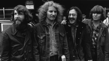 Black and white HD desktop wallpaper featuring the band Creedence Clearwater Revival smiling and standing outdoors, capturing a classic music moment.