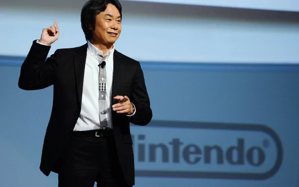 HD desktop wallpaper featuring Shigeru Miyamoto speaking at a Nintendo event.