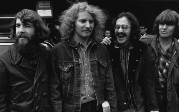 Black and white HD desktop wallpaper featuring the band Creedence Clearwater Revival smiling and standing outdoors, capturing a classic music moment.