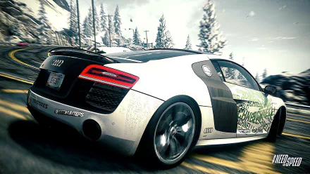 HD PC desktop wallpaper featuring a dynamic scene from the video game Need For Speed: Rivals, showcasing a sleek Audi R8 speeding through a snowy forest road.