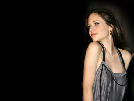 HD desktop wallpaper featuring celebrity Zooey Deschanel in a stylish silver dress against a dark background.