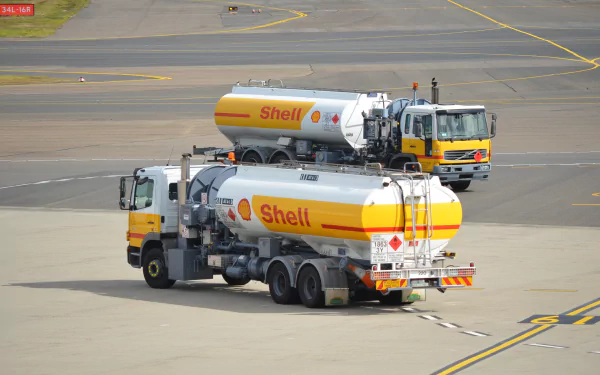 HD desktop wallpaper showing Shell-branded Mercedes tanker vehicles at an airport, servicing a VIP jet on the tarmac.