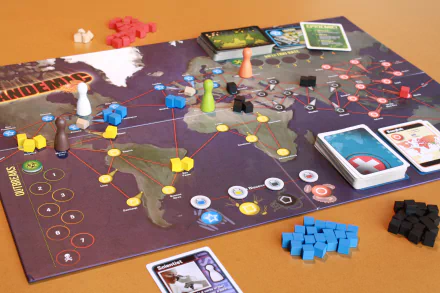 HD desktop wallpaper featuring the board game Pandemic with pieces and cards spread out, symbolizing global crisis management.