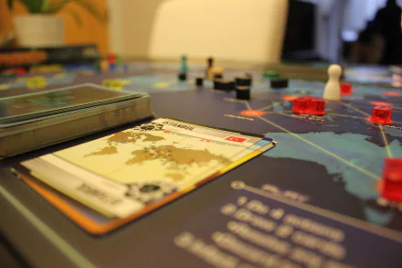 HD desktop wallpaper featuring a close-up of the board game Pandemic, symbolizing strategic gameplay during a health crisis.