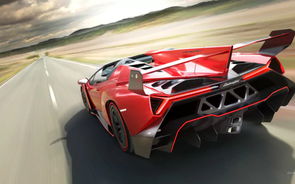 HD desktop wallpaper featuring a striking red Lamborghini Veneno Roadster speeding down an open highway under a dramatic sky.