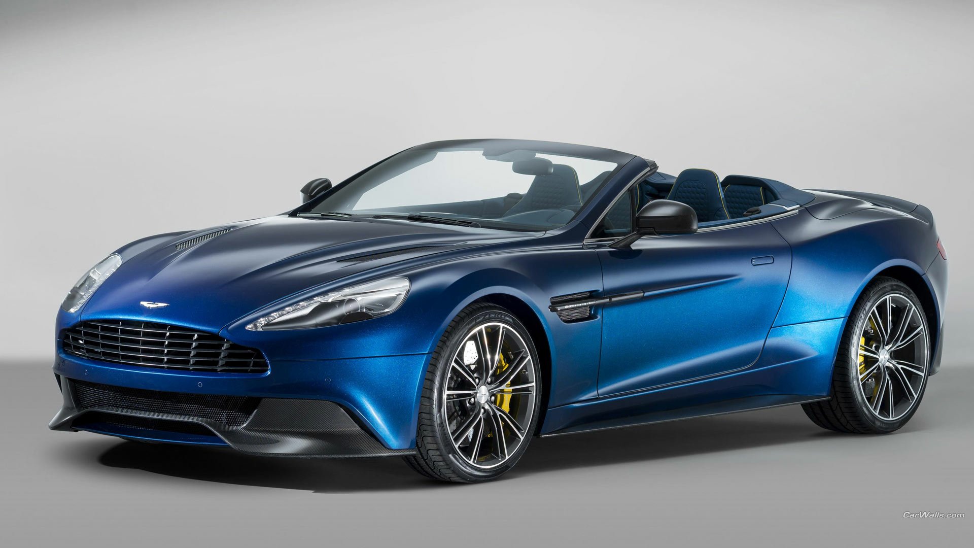 Blue 2014 Aston Martin Vanquish Volante vehicle, convertible, front three-quarter view on neutral backdrop — HD PC desktop wallpaper and background.