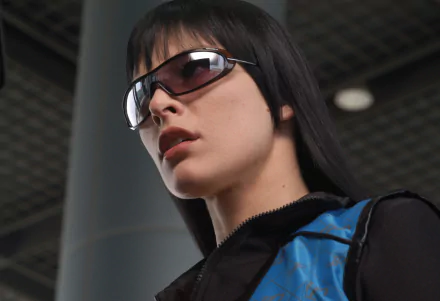 HD PC desktop wallpaper featuring Milla Jovovich in her iconic look from the movie Ultraviolet, wearing dark sunglasses and a blue-black outfit.