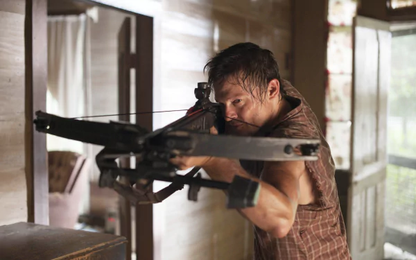 Daryl Dixon, portrayed by Norman Reedus in The Walking Dead, takes aim with a crossbow in this intense HD desktop wallpaper, capturing the essence of the thrilling TV show.