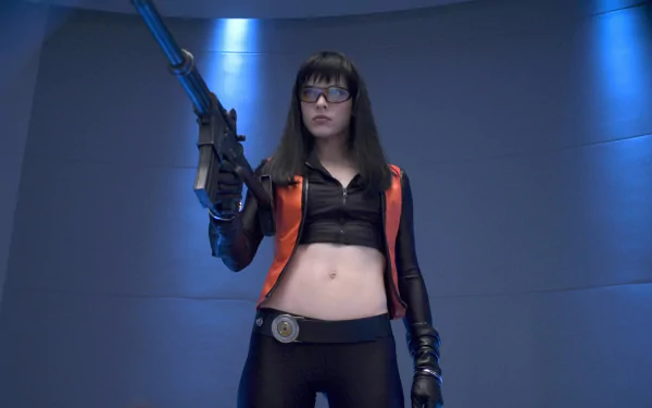 HD PC desktop wallpaper featuring a character from the movie Ultraviolet, holding a futuristic weapon in a sleek, sci-fi setting with blue lighting.