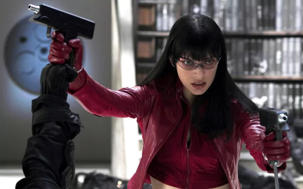 HD PC desktop wallpaper featuring a scene from the movie Ultraviolet, showing the protagonist in a red jacket aiming two guns in an intense action moment.