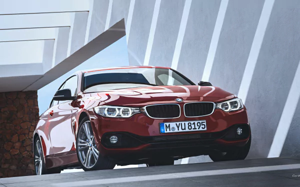 HD desktop wallpaper featuring a red BMW 4 Series Coupe parked in a modern architectural setting with sharp light and shadow contrasts.