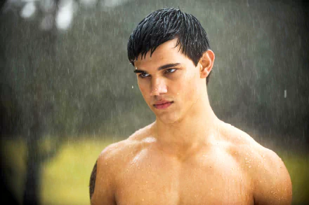 A striking 4K Ultra HD desktop wallpaper featuring Taylor Lautner, showcasing him with a serious expression as rain pours around him, highlighting his dynamic presence.