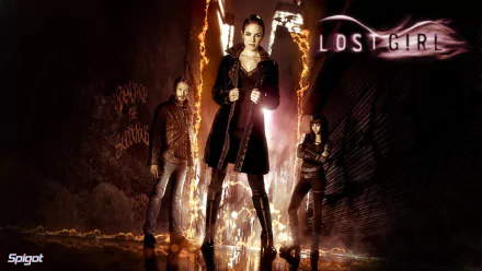A dramatic HD wallpaper from the TV show Lost Girl, featuring the main characters in a dark, mystical setting with vibrant flames and the show's title prominently displayed.