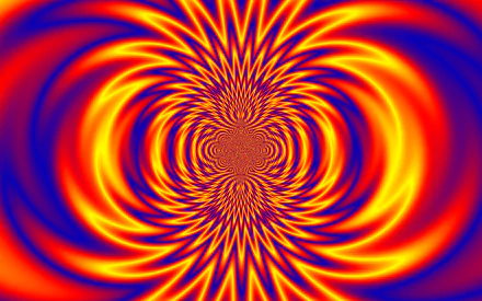 Vibrant HD PC desktop wallpaper featuring an abstract hypnotic pattern with swirling rainbow colors in dynamic red, yellow, and blue hues.