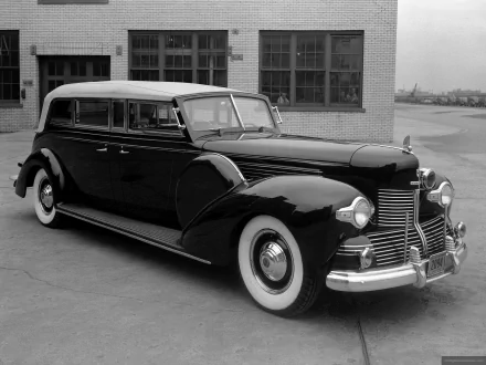 Black 1942 Lincoln Sunshine Special Sedan parked before a brick industrial building, classic Lincoln vehicle; HD PC desktop wallpaper and background.