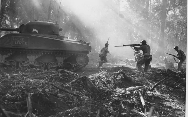 Black-and-white military scene with an M4 Sherman tank and infantry advancing through a misty, debris-strewn forest — HD PC desktop wallpaper/background.