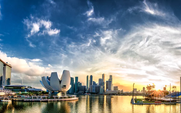A stunning 4K Ultra HD man-made skyline of Singapore at sunset, featuring modern architecture and vibrant clouds over the waterfront.