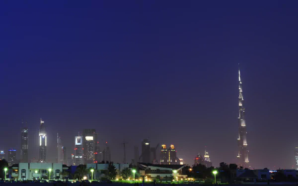A stunning HD wallpaper of Dubai's skyline at night, featuring the iconic Burj Khalifa illuminated against a dark sky, showcasing the city's impressive man-made architecture.