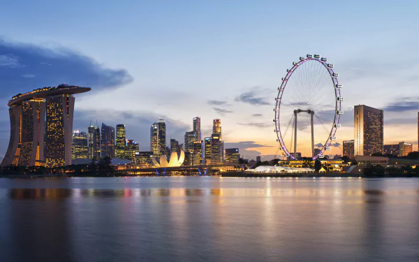 4K Ultra HD desktop wallpaper showcasing Singapore’s skyline at dusk with Marina Bay Sands and the Singapore Flyer illuminated along the waterfront.
