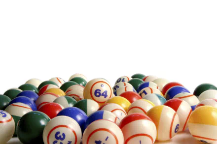 2K Quad HD PC wallpaper of man-made bingo balls piled on a white background, colorful numbered balls with 64 prominent.