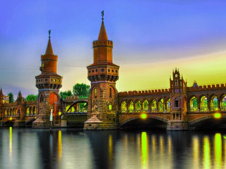 Oberbaum Bridge in Berlin, Germany, illuminated at night over the Spree River, captured in an HD cityscape wallpaper.