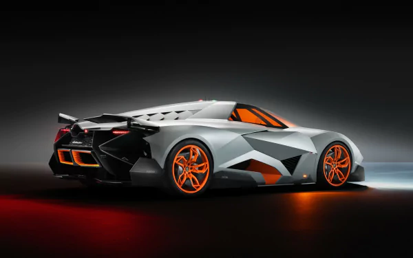 HD PC desktop wallpaper featuring a sleek Lamborghini Egoista with a futuristic design and vibrant orange accents against a dark background.