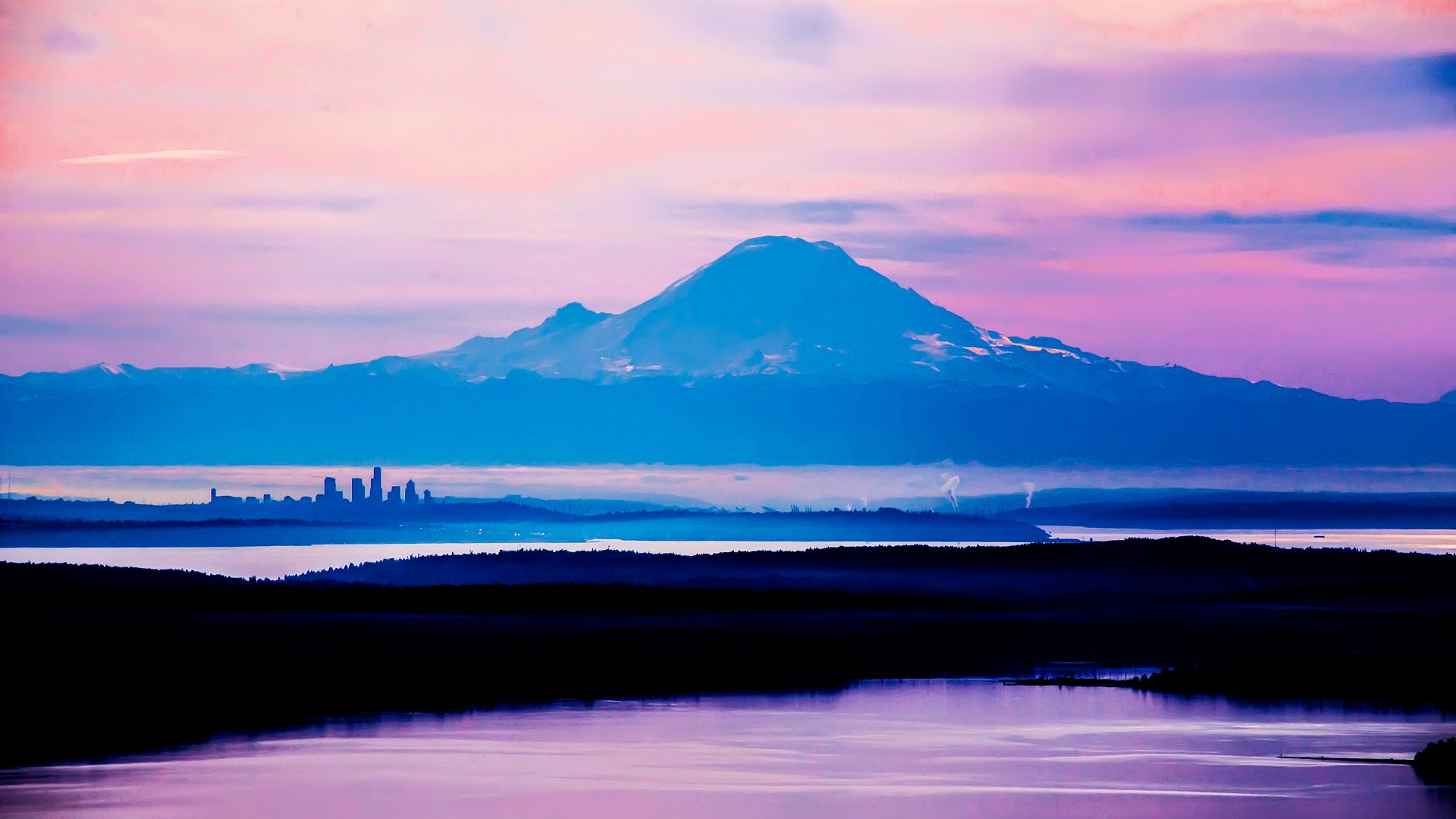 Pastel sunrise over a snow-capped mountain with layered shorelines and reflective water — 4K Ultra HD PC desktop wallpaper and background showcasing nature mountain scenery.