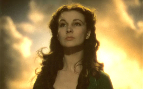 HD PC desktop wallpaper background: luminous portrait of a woman from the movie Gone With The Wind, gazing upward against glowing, cloud-filled golden sky.