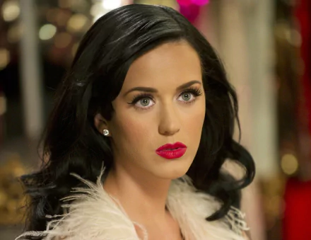 HD desktop wallpaper of American singer Katy Perry, showcasing her with elegant makeup and a thoughtful expression.