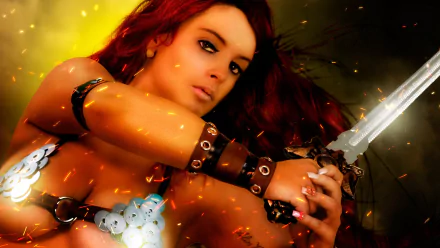 HD PC desktop wallpaper featuring Red Sonja, the fierce comic warrior, with fiery hair and armor, gripping a sword amid glowing embers and dynamic lighting.