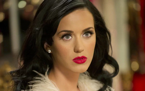 HD desktop wallpaper of American singer Katy Perry, showcasing her with elegant makeup and a thoughtful expression.