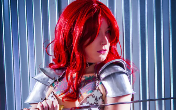 HD PC desktop wallpaper featuring a woman cosplaying as Red Sonja, with vibrant red hair and detailed armor against a metallic striped background.