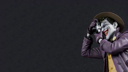 A vibrant HD wallpaper featuring the Joker from *Batman: The Killing Joke*, capturing his iconic pose with a camera against a dark background.