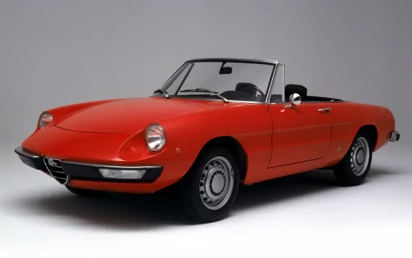 HD desktop wallpaper featuring a vibrant red Alfa Romeo Spider convertible, showcasing the classic design of this iconic Alfa Romeo vehicle.