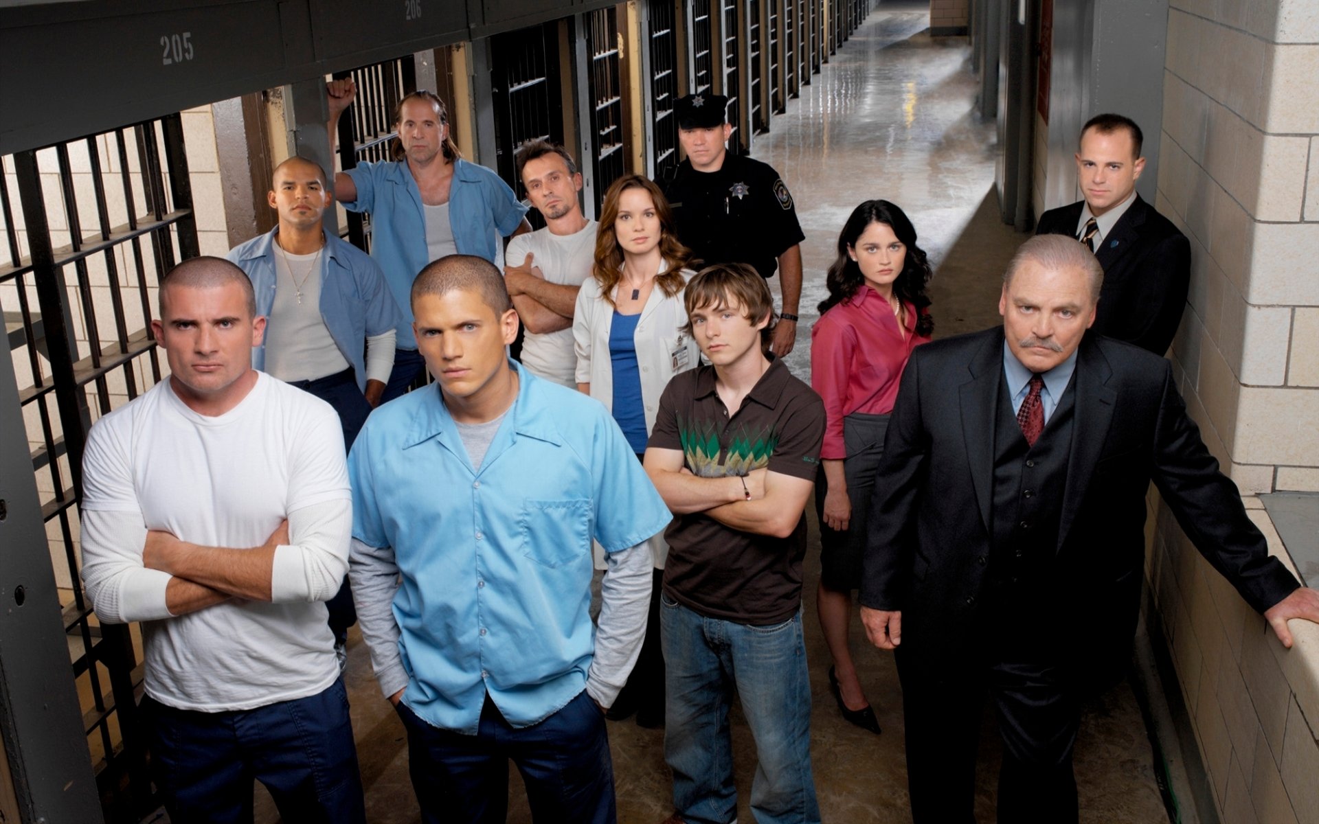 HD wallpaper of TV show Prison Break featuring characters Michael Scofield, Lincoln Burrows, and Fernando Sucre, among others, set against a prison background.