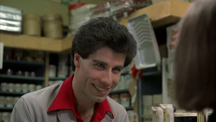 HD PC desktop wallpaper of a smiling man in a 1970s grocery setting with disco-era styling and a movie-inspired Saturday Night Fever vibe.