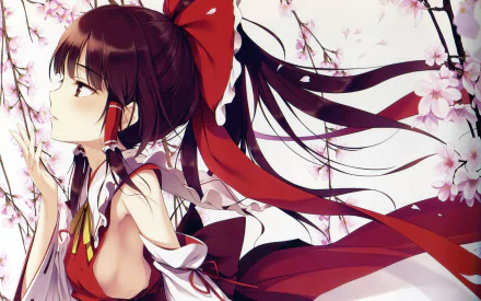 Reimu Hakurei stands gracefully amidst blooming cherry blossoms in this HD Touhou anime wallpaper, showcasing her signature red outfit and elegant pose.