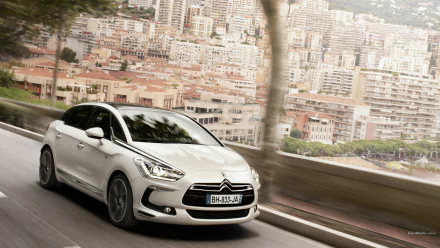 White Citroën DS5 vehicle speeding along a coastal city road with motion blur — HD PC desktop wallpaper/background.