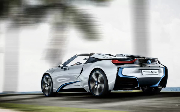 Silver BMW i8 Concept Spyder vehicle shown in rear three-quarter view against blurred palms, presented as an HD PC desktop wallpaper/background.