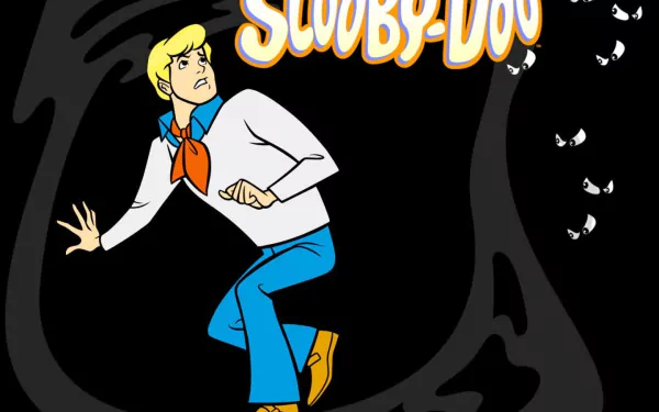 A vibrant HD desktop wallpaper featuring Fred from Scooby-Doo, poised in a suspenseful moment against a dark background, capturing the essence of the classic TV show.