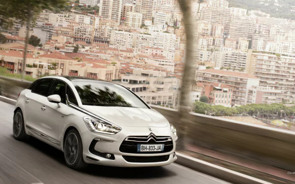 White Citroën DS5 vehicle speeding along a coastal city road with motion blur — HD PC desktop wallpaper/background.