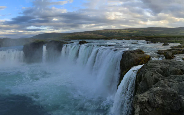 A breathtaking sunset over Goðafoss waterfall in Iceland, showcasing the vibrant colors of nature and the majestic flow of water in stunning 4K Ultra HD.