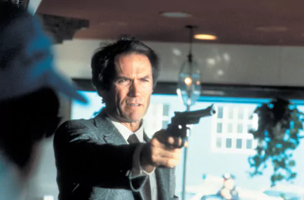Actor aiming a revolver in a tense scene from the movie Sudden Impact — 2K Quad HD PC desktop wallpaper/background.