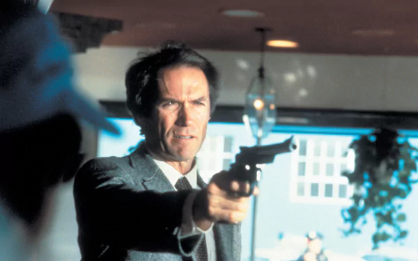 Actor aiming a revolver in a tense scene from the movie Sudden Impact — 2K Quad HD PC desktop wallpaper/background.