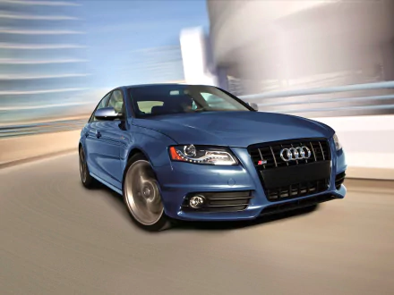 HD desktop wallpaper featuring a sleek blue Audi S4 car in motion against a blurred urban background, showcasing the vehicle's sporty design and dynamic presence.