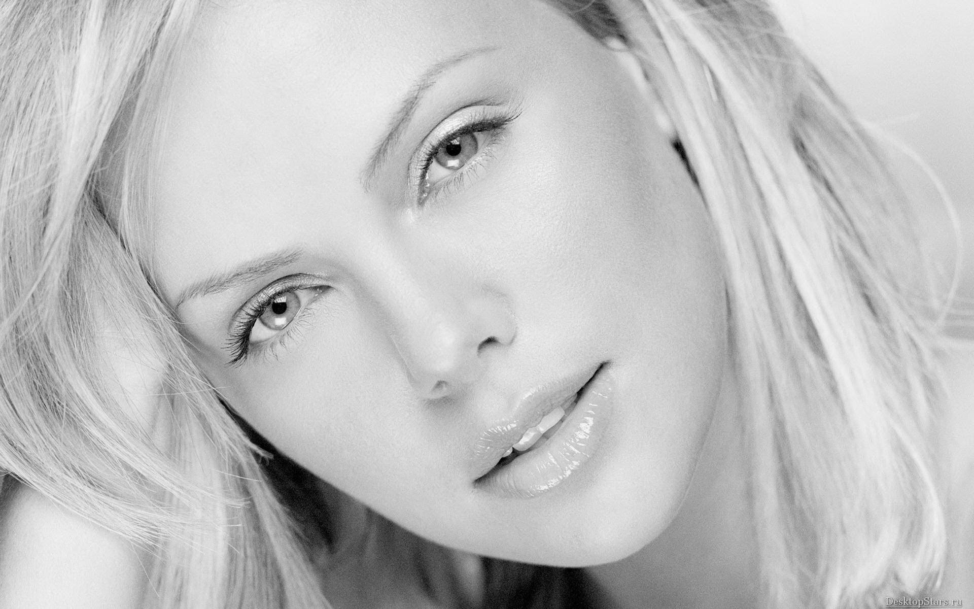 A striking black and white HD wallpaper featuring a close-up of actress Charlize Theron, showcasing her captivating expression and radiant beauty.