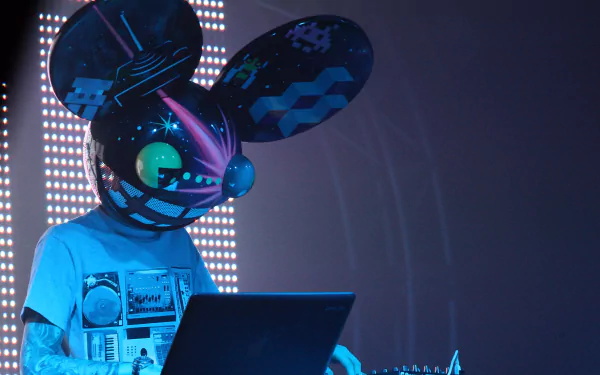 A vibrant HD wallpaper featuring Deadmau5 performing at a concert, showcasing his iconic mau5head while engaged with his laptop amidst dynamic lighting.