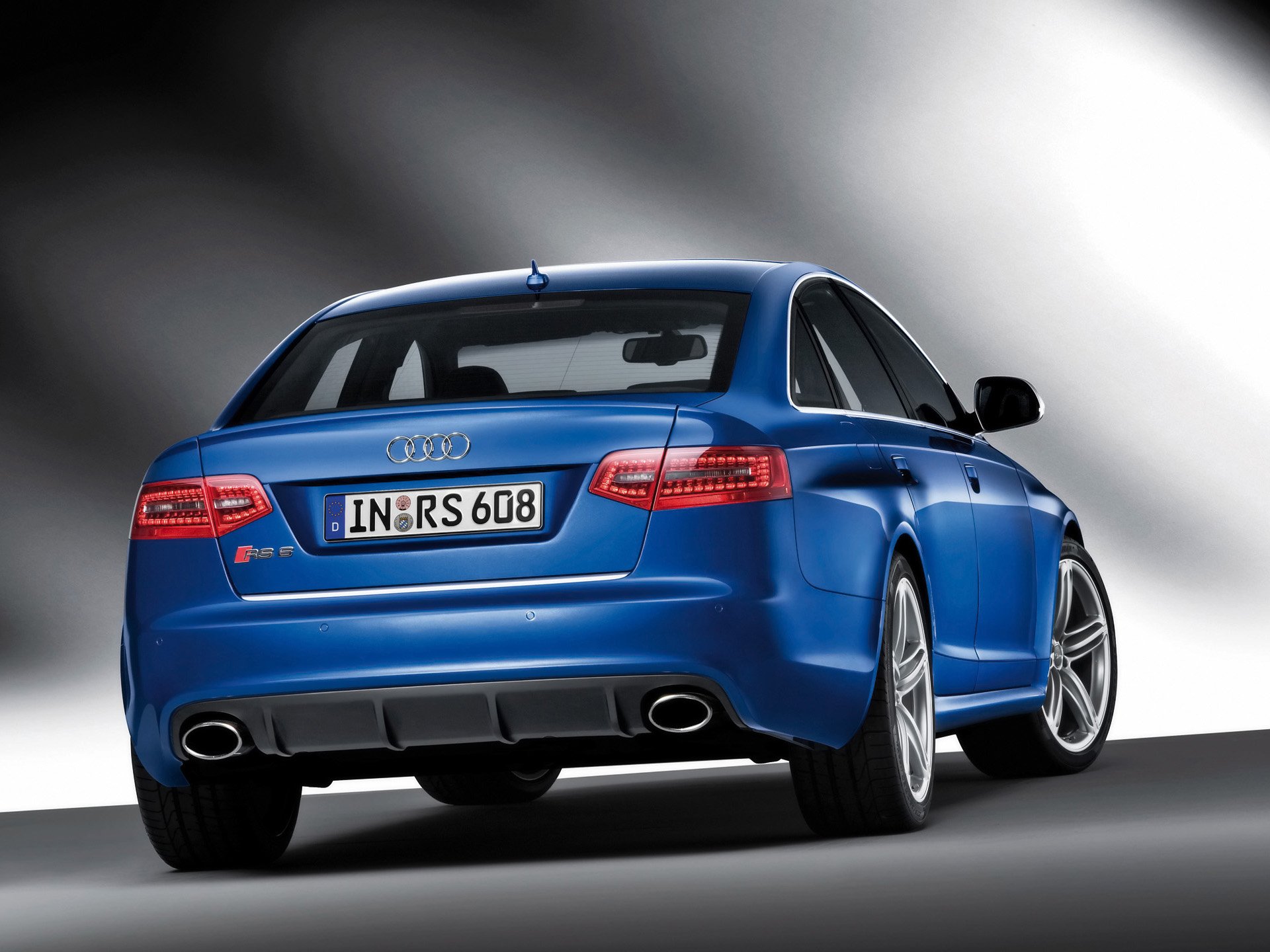 HD PC desktop wallpaper: blue Audi RS6 vehicle, rear three-quarter view on a soft gradient background.