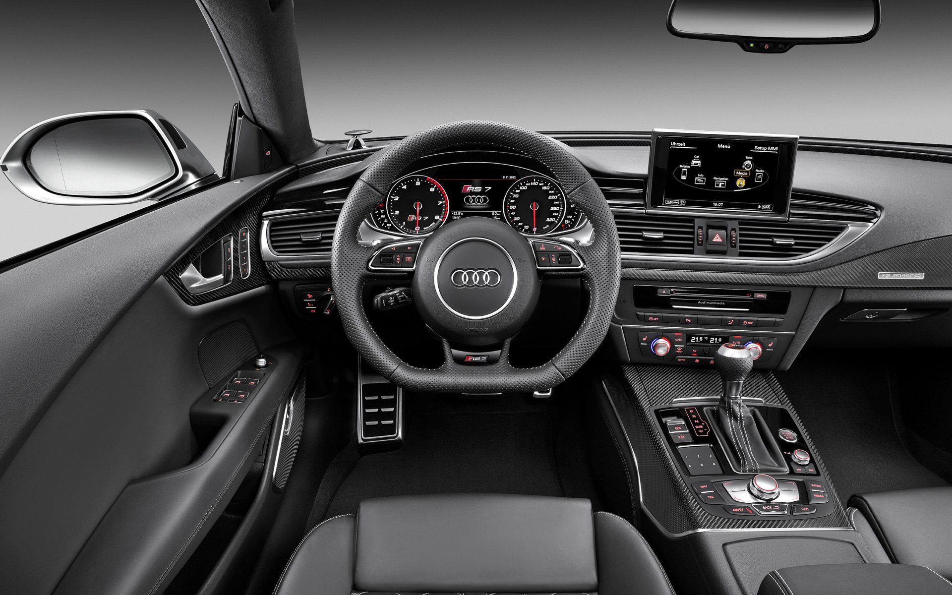 HD PC desktop wallpaper featuring the sleek interior dashboard and steering wheel of an Audi RS7 vehicle.